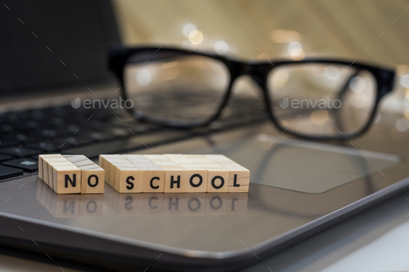 Virtual learning concept with wood block letters on laptop