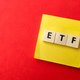 Toys word and sticky note with word ETF on red background. - PhotoDune Item for Sale