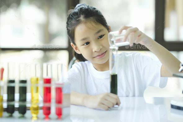Little child with learning science class in school laboratory - Stock Photo - Images