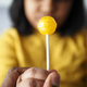 child holding yellow color lollipop candy  - PhotoDune Item for Sale