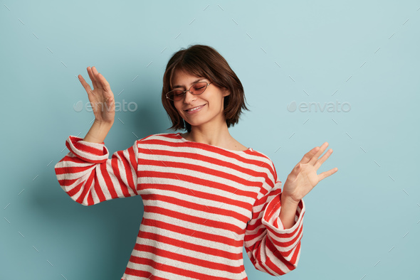 Happy young mixed race female dancing in studio - Stock Photo - Images