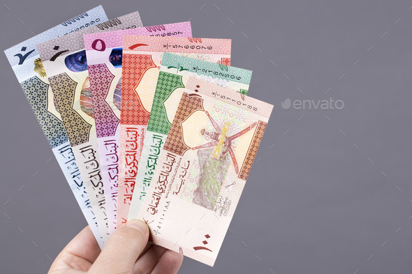Omani money in the hand on a gray background - Stock Photo - Images