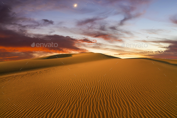 Sunset over the sand dunes in the desert. Arid landscape of the Sahara desert. - Stock Photo - Images