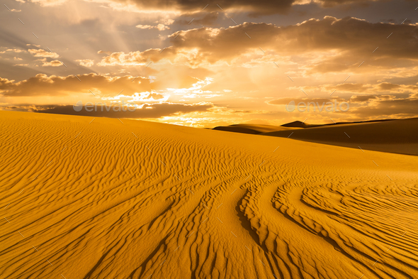 Sunset over the sand dunes in the desert. Arid landscape of the Sahara desert. - Stock Photo - Images