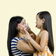 Side view of woman and little girl are making faces to each other. - PhotoDune Item for Sale