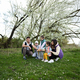 Family with three kids in spring meadow on the background of a flowering tree. - PhotoDune Item for Sale