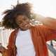 Black woman wearing headphones and dancing on the bridge - PhotoDune Item for Sale
