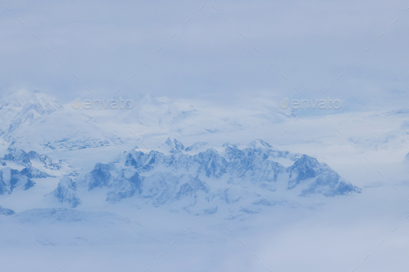 landscape of Greenland mountain peaks, with their high altitude and snow covered summits, is sight - Stock Photo - Images