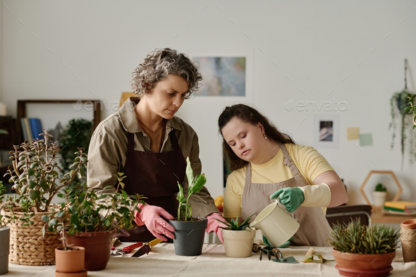 Girl with down syndrome planting plants Stock Photo by AnnaStills ...