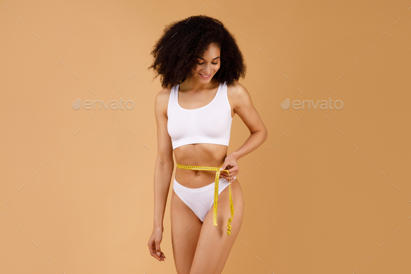 Woman Holds A Measuring Tape Around Her Waist Stock Photo, Picture