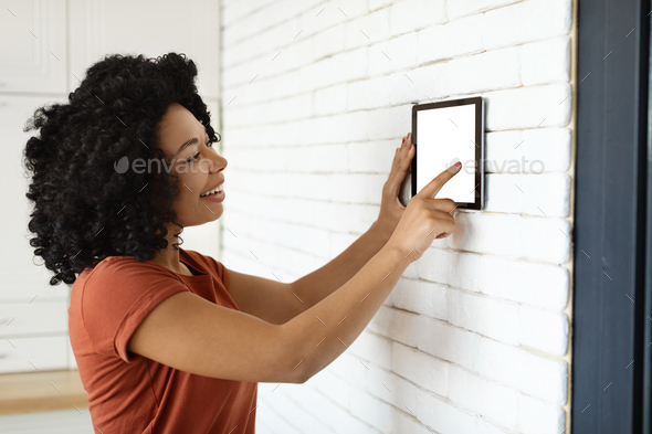 Innovative Technology. Black Woman Using Blank Digital Tablet For Smart Home Settigns