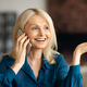 Happy attractive mature businesswoman calling by smartphone, talking and gesturing, sitting in - PhotoDune Item for Sale