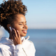 Smiling Young African American Woman Wearing Wireless Headphones Listening Music Outdoors - PhotoDune Item for Sale