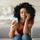 Bored Young Black Female Looking At Smartphone Screen At Home - PhotoDune Item for Sale