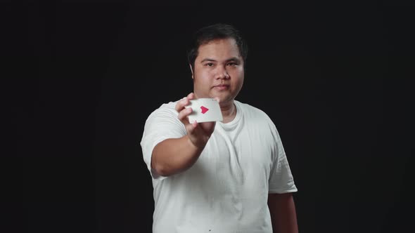 Asian Magician Is Making Trick Shaking Hand And Changing Card alt