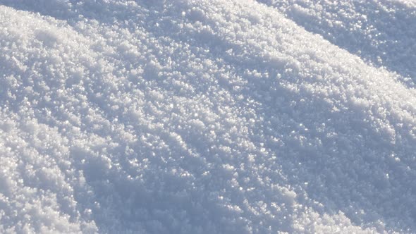 Crystals of first snow sparkling under sun slow tilt 4K 2160p 30fps UltraHD footage - White frozen c alt