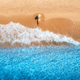 Aerial view of woman on sandy beach and blue sea with waves - PhotoDune Item for Sale