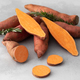 Raw sweet potatoes whole and cut. Orange kumara, sweet potato. Harvesting of root crops. - PhotoDune Item for Sale