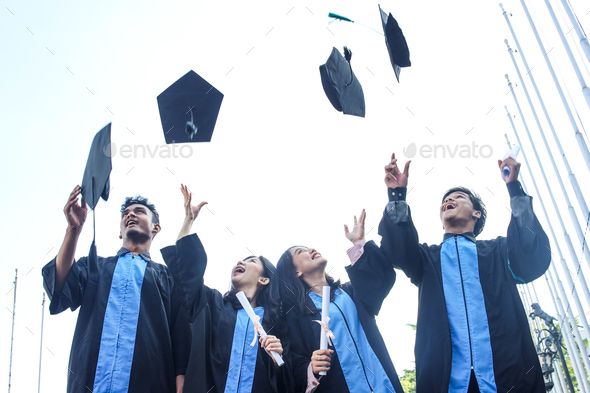 Bachelor students throwing graduation cap