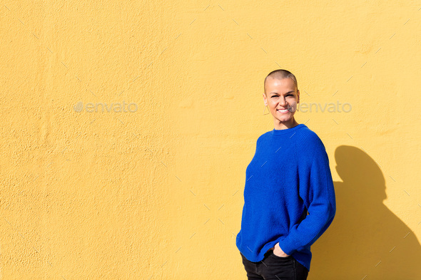 woman with a shaved head smiling looking at camera - Stock Photo - Images