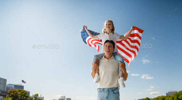 Patriotic holiday, family with American flag - Stock Photo - Images