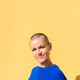woman with a shaved head smiling looking at camera - PhotoDune Item for Sale