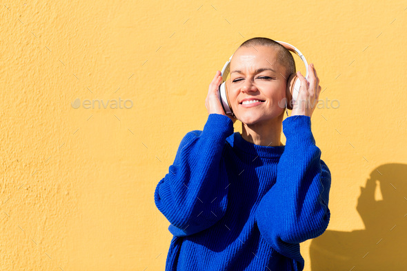 woman enjoying happy the music in her headphones - Stock Photo - Images