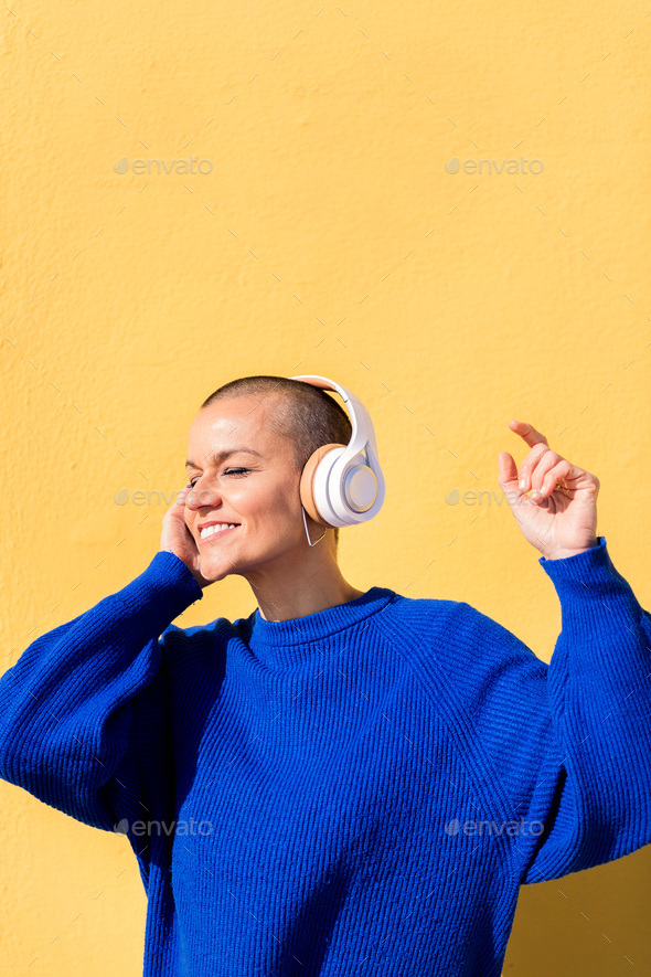woman dancing listening to music in her headphones - Stock Photo - Images