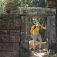 Man walking through old ruins and coming to ancient temple in jungle - PhotoDune Item for Sale