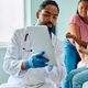 Black pediatrician and small boy using digital tablet at doctor&#39;s office. - PhotoDune Item for Sale