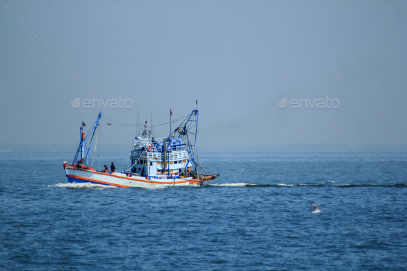 Large fishing boats in the sea. Stock Photo by puripatt