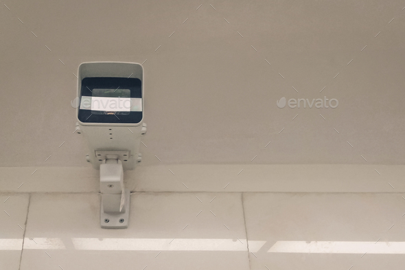 city video surveillance system - security camera under ceiling, front view - Stock Photo - Images