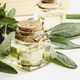 Sage oil in bottles, green sage leaf on white table, copy space - PhotoDune Item for Sale