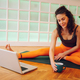 Girl picking up a cup of tea while having an online meeting in a yoga studio. - PhotoDune Item for Sale