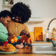 A happy interracial mother and son are playing with toys in the kitchen at home. - PhotoDune Item for Sale