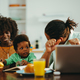 A contemporary african american family at the breakfast table in the morning. - PhotoDune Item for Sale