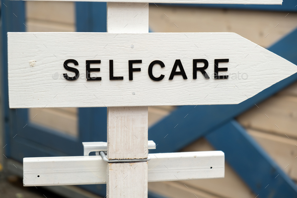 Street signs with text SELF CARE. Concept of mental spiritual health. Take care of yourself