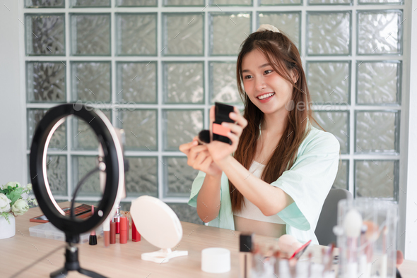 Beauty blogger concept, Young woman apply blush on to introduce product and record video for Vlog