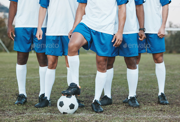 Soccer ball, sports group and feet of a team on a field to start fitness training or game outdoor.