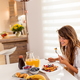 Woman having breakfast at home - PhotoDune Item for Sale