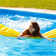 Woman relaxing at the swimming pool while on summer vacation - PhotoDune Item for Sale