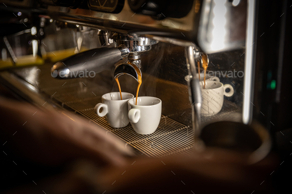 Espresso machine pouring coffee in cups Stock Photo by ©bogdan