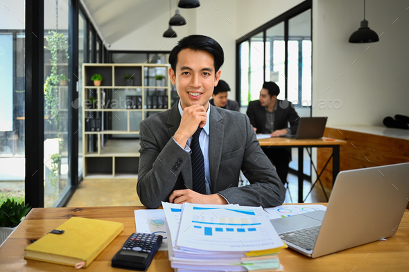 Male marketing business manager in formal clothes sitting at work desk. - Stock Photo - Images