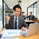 Excited asian male office worker looking at laptop screen, celebrating business success. - PhotoDune Item for Sale