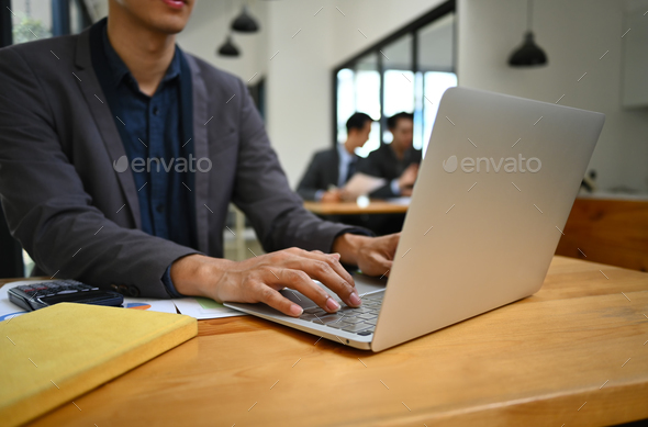 Cropped shot of male entrepreneur working online sale marketing at modern workplace. - Stock Photo - Images