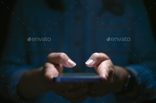 Close Up Of Woman Using Mobile Phone With Finger Poised Above Screen - Stock Photo - Images
