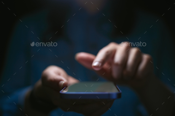 Close Up Of Woman Using Mobile Phone With Finger Poised Above Screen - Stock Photo - Images