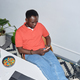 Top view of black adult man using smartphone while relaxing at workplace - PhotoDune Item for Sale