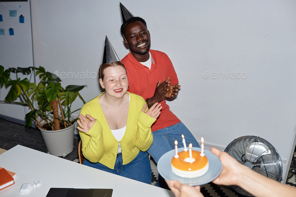People celebrating birthday in office with flash - Stock Photo - Images