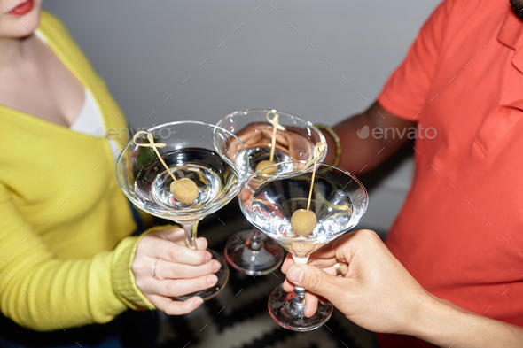 Young people holding glasses and toasting - Stock Photo - Images